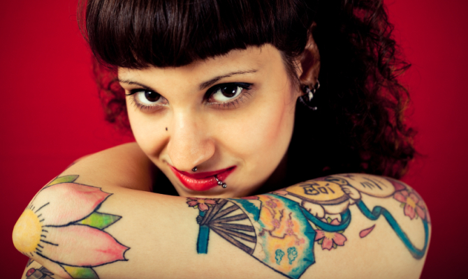 Donna tatuata con piercing